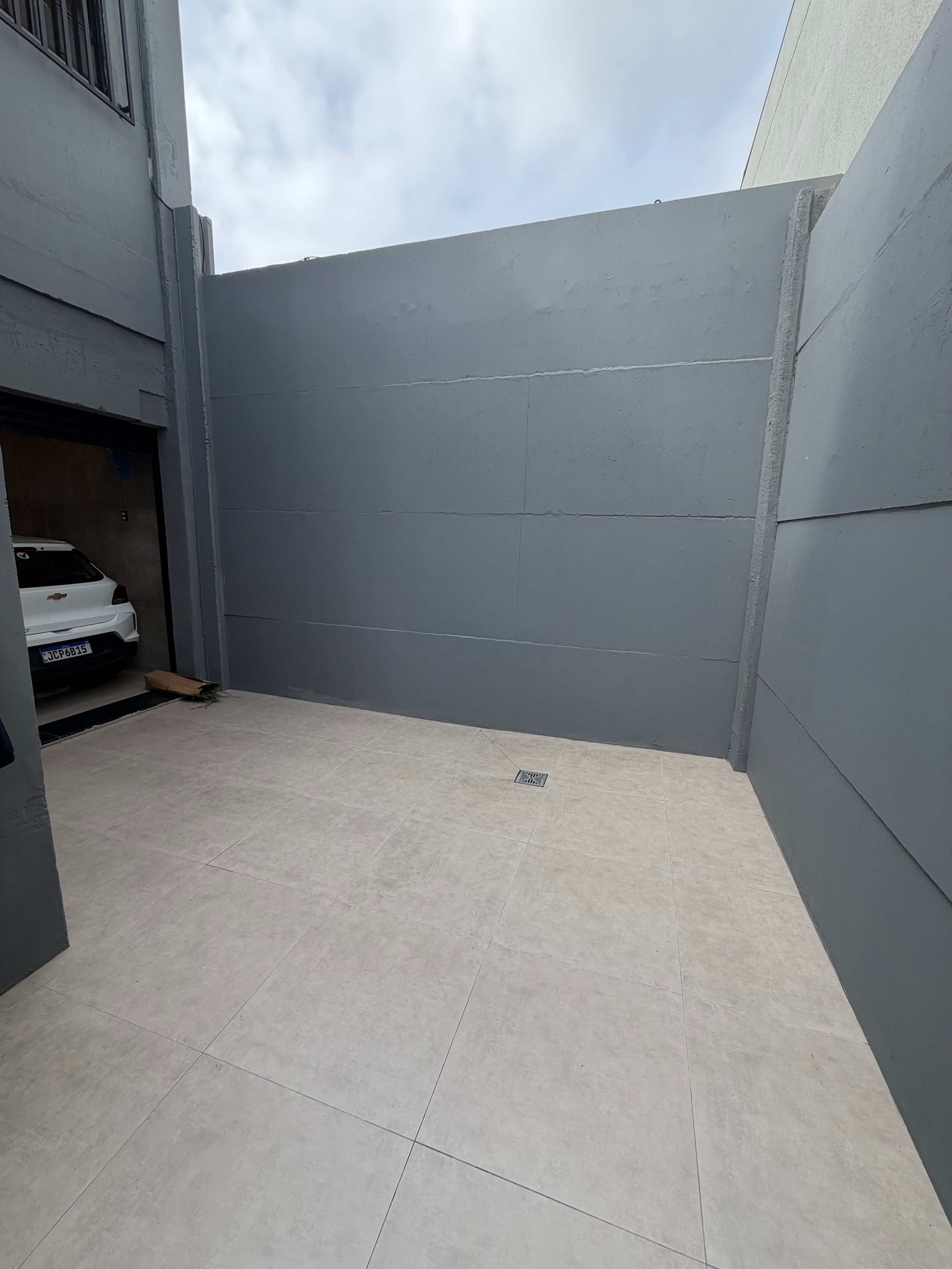 Pátio descoberto com piso, ralo e abertura para o interior